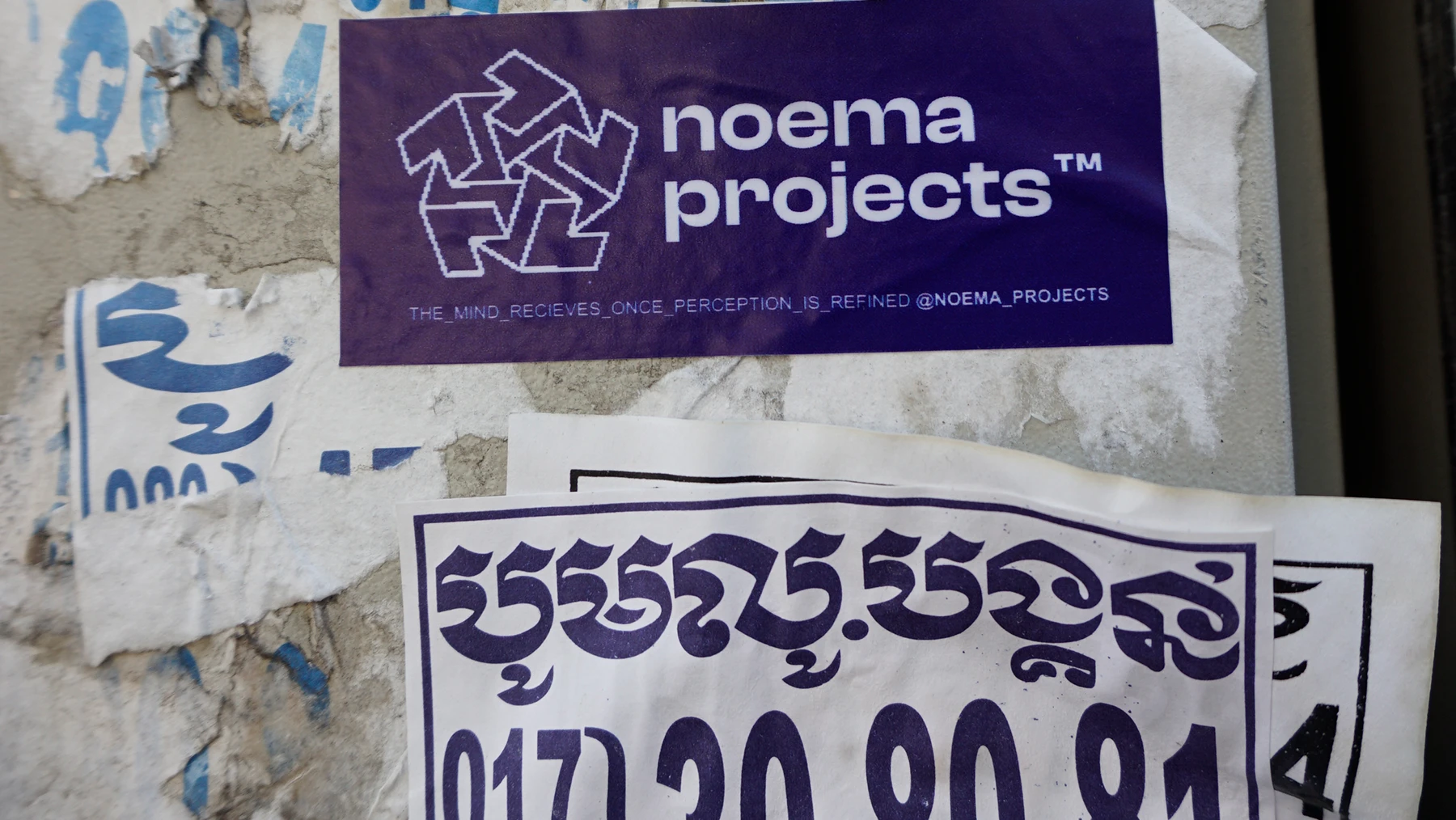 Noema Projects sticker applied in a street environment